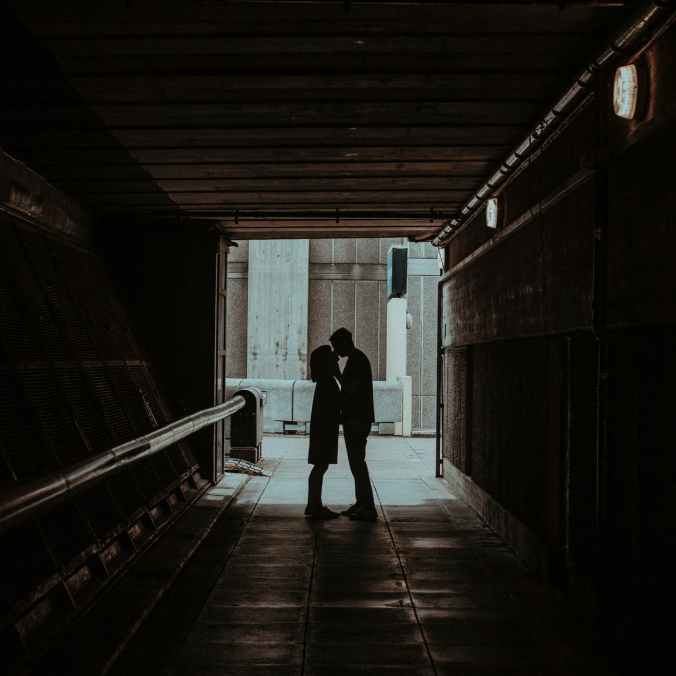 photo of couple kissing in hallway