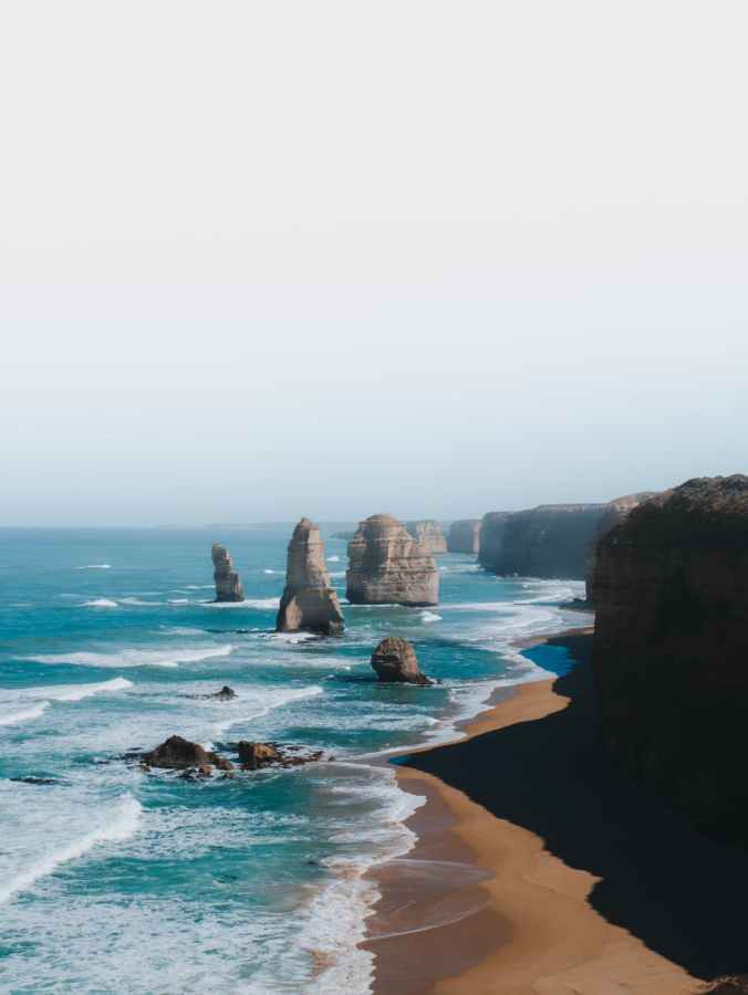 brown rock formation on sea shore